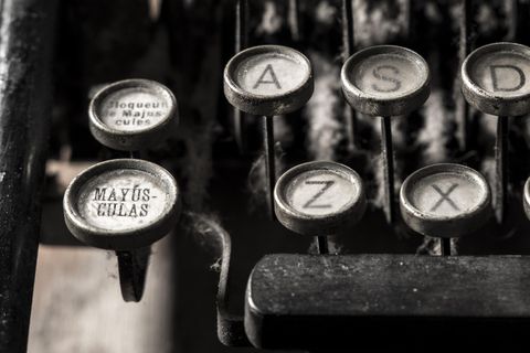 Close-up of keys on an old Spanish typewriter, part of the space bar, a, s, d, z, x, and MAYÚSCULAS (capslock) with release above it

